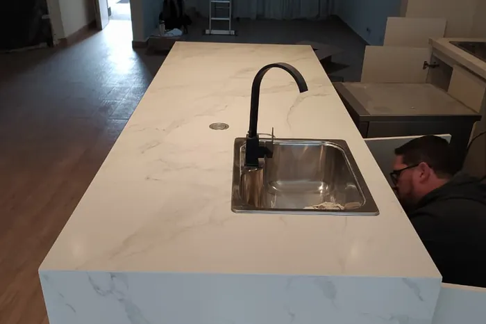 Mesada de cocina en mármol con caída lateral y bacha bajomesada